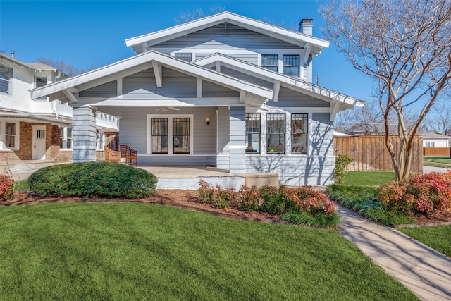 view of front of home featuring covered porch and a front yard