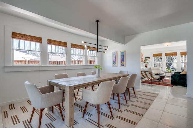 tiled dining space featuring a notable chandelier