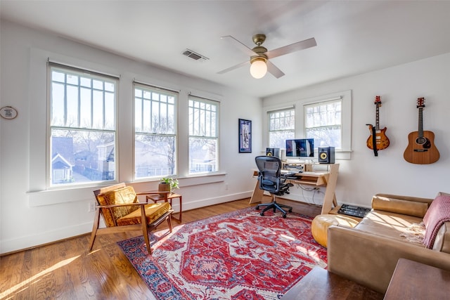 office space with hardwood / wood-style flooring, ceiling fan, and a healthy amount of sunlight