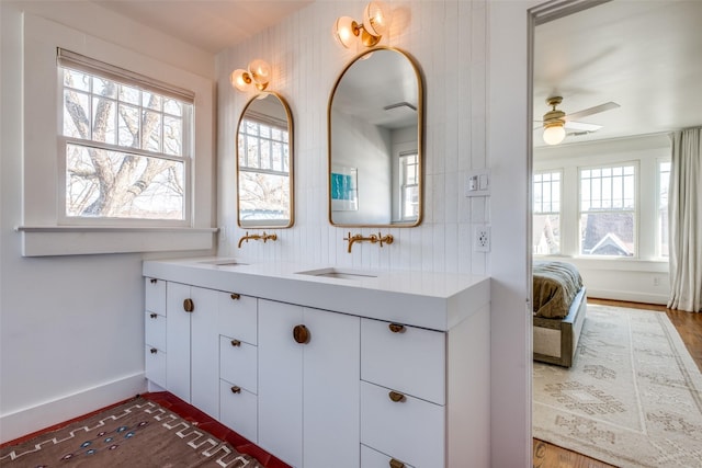 bathroom featuring hardwood / wood-style floors, ceiling fan, backsplash, and vanity