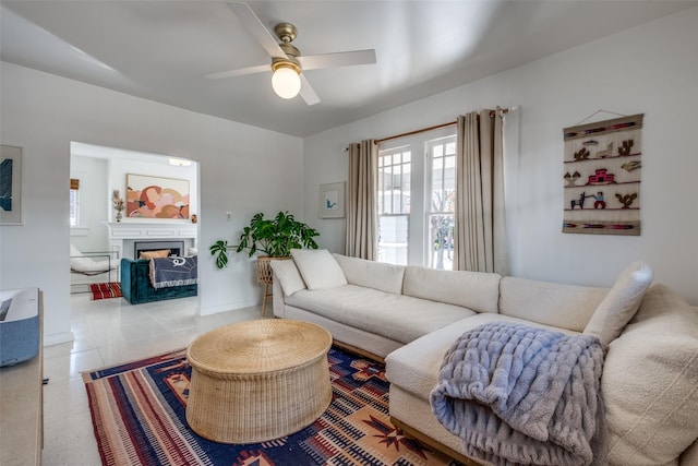 living room featuring ceiling fan and light tile patterned floors