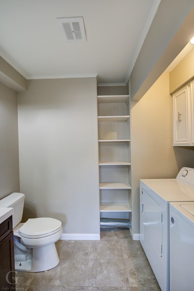 laundry room featuring crown molding and washer and dryer