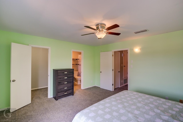 bedroom featuring connected bathroom, ceiling fan, a spacious closet, carpet floors, and a closet