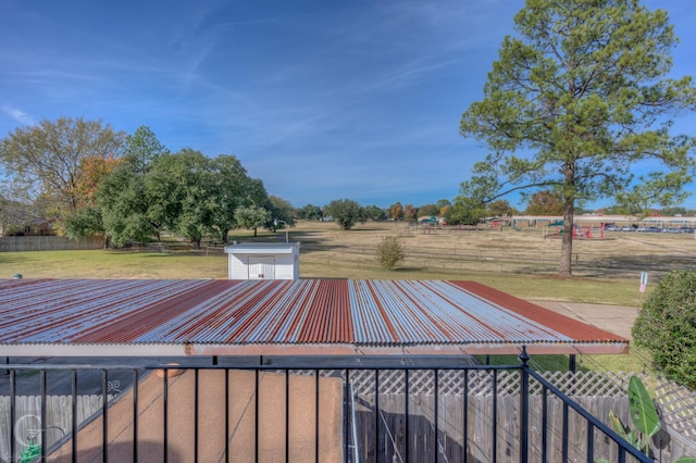 wooden deck featuring a storage unit and a lawn