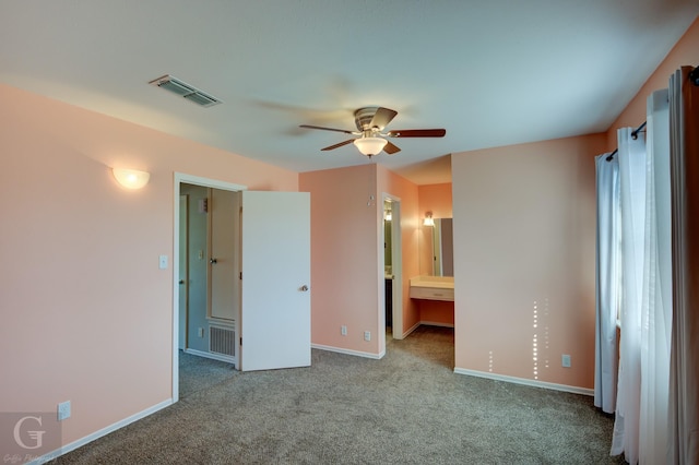 unfurnished bedroom featuring ceiling fan, light carpet, and connected bathroom