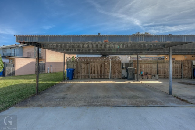 exterior space with a carport and a lawn