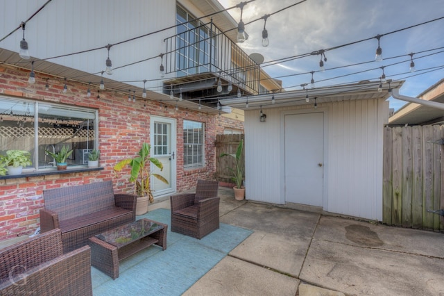 view of patio / terrace with an outdoor living space and a storage unit