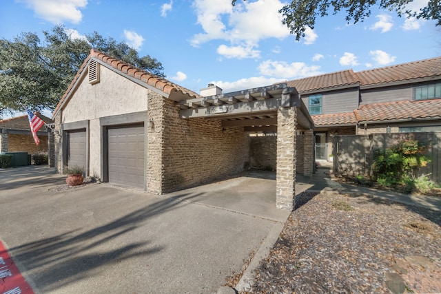 view of front of home featuring a garage and a carport