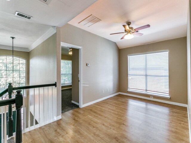 spare room featuring ceiling fan, light hardwood / wood-style flooring, and ornamental molding