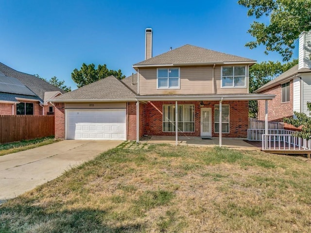 view of front property featuring covered porch, a garage, and a front yard