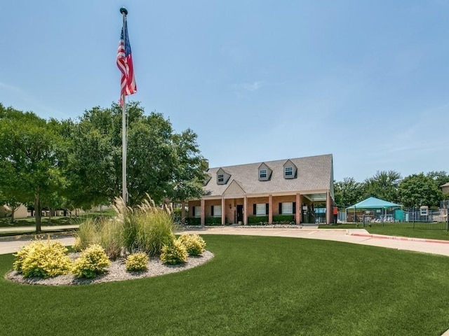 cape cod home with a front lawn