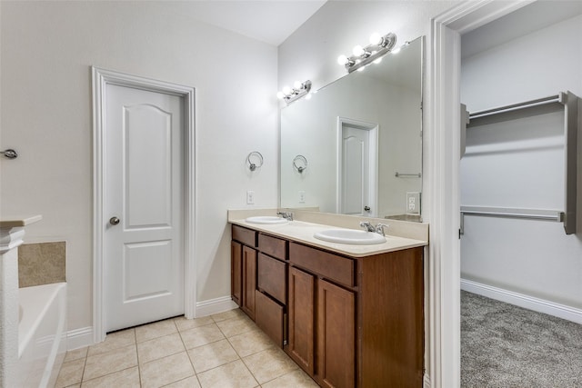 bathroom featuring a tub to relax in, tile patterned flooring, and vanity