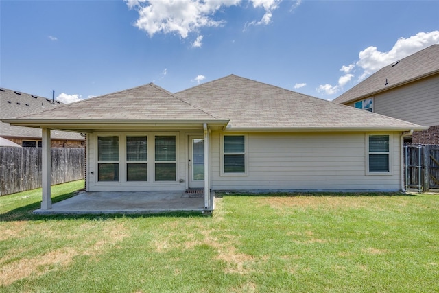 rear view of house with a lawn and a patio area