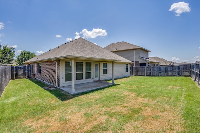 back of property featuring a yard and a patio