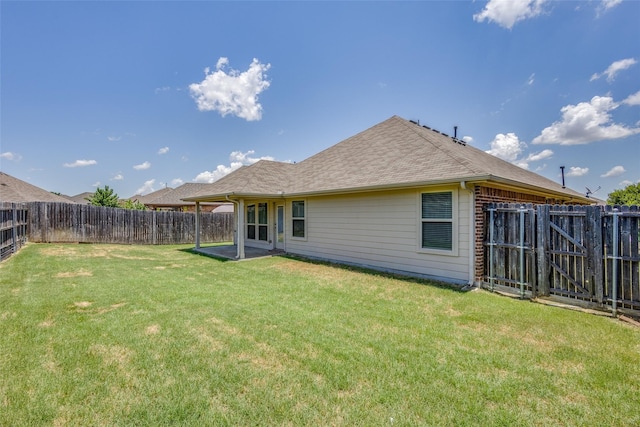 rear view of house featuring a lawn