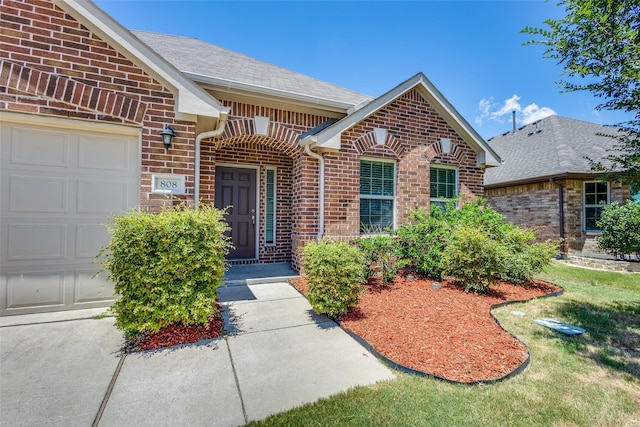 doorway to property with a garage