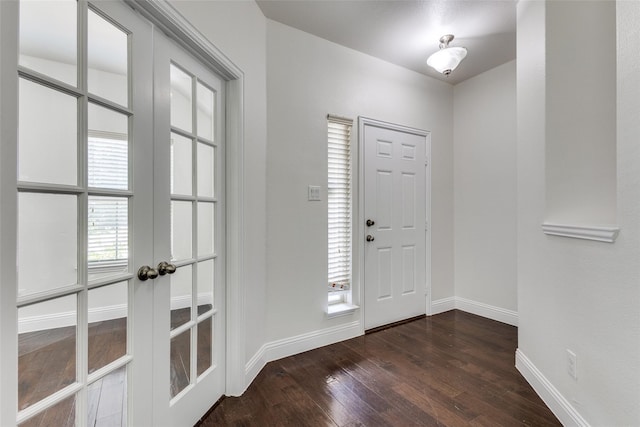 entryway with dark hardwood / wood-style flooring and french doors