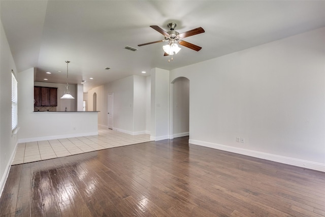 unfurnished living room with ceiling fan and light wood-type flooring