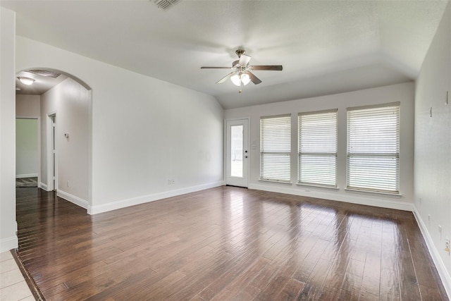 unfurnished room with ceiling fan, lofted ceiling, and dark wood-type flooring