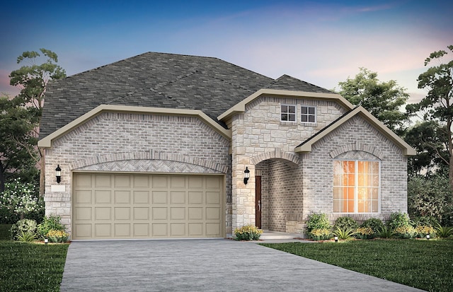 french country style house featuring a garage and a lawn