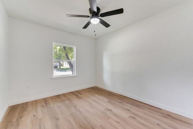 empty room with ceiling fan and light hardwood / wood-style floors