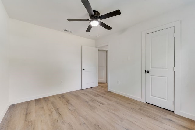 unfurnished bedroom with ceiling fan and light wood-type flooring