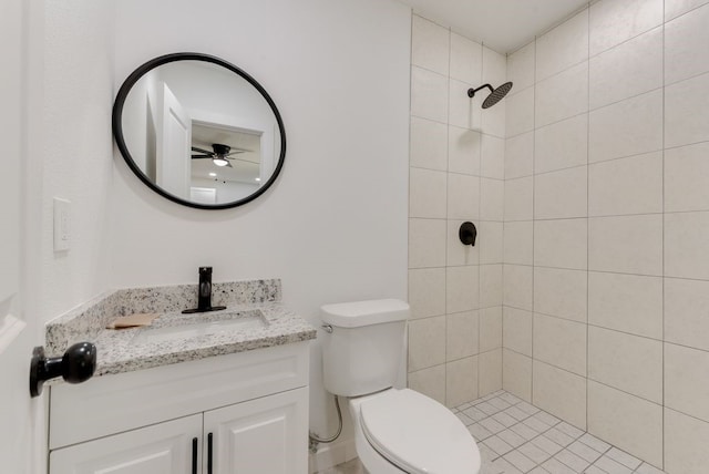 bathroom with vanity, toilet, and tiled shower