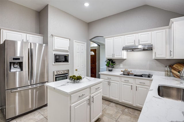 kitchen with built in microwave, stainless steel fridge with ice dispenser, a center island, and white cabinets