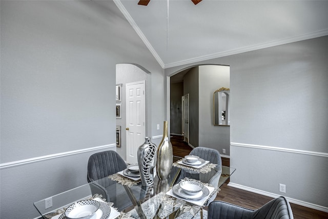 dining room with crown molding, dark hardwood / wood-style floors, and vaulted ceiling