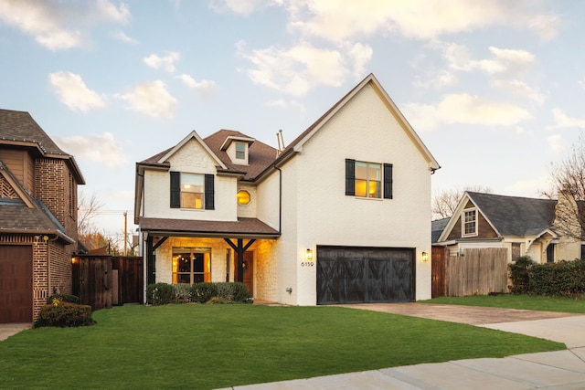 view of front of home with a garage and a front lawn