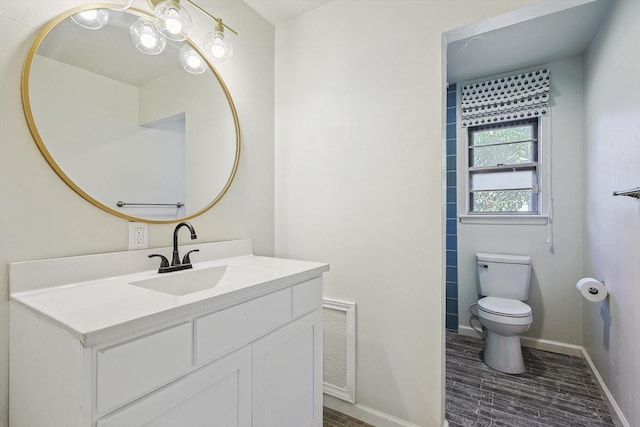 bathroom with vanity, hardwood / wood-style floors, and toilet