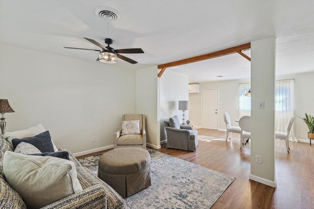 living room featuring hardwood / wood-style floors and ceiling fan