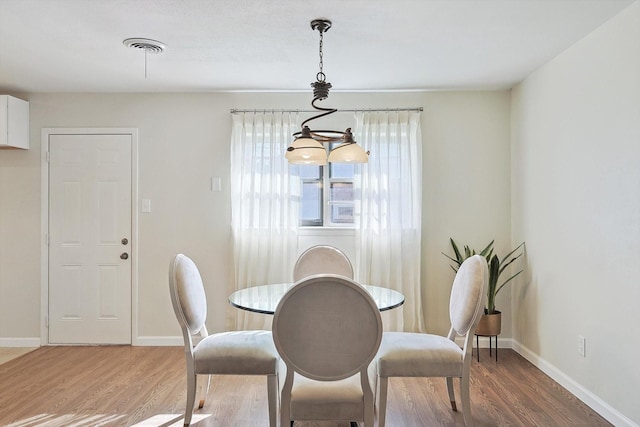 dining room with hardwood / wood-style flooring