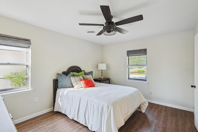 bedroom with dark wood-type flooring and ceiling fan