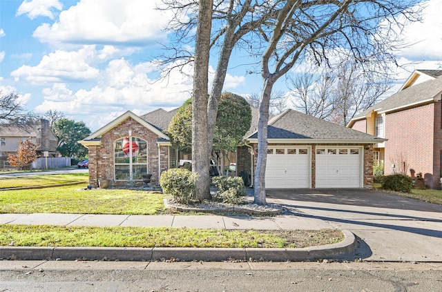 view of front of house with a garage and a front lawn