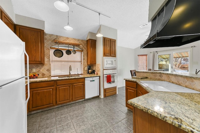 kitchen with a textured ceiling, white appliances, ventilation hood, sink, and hanging light fixtures