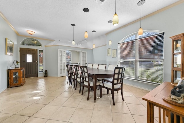 dining area featuring a textured ceiling, light tile patterned floors, ornamental molding, and french doors