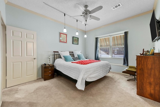 carpeted bedroom featuring ceiling fan, crown molding, and a textured ceiling