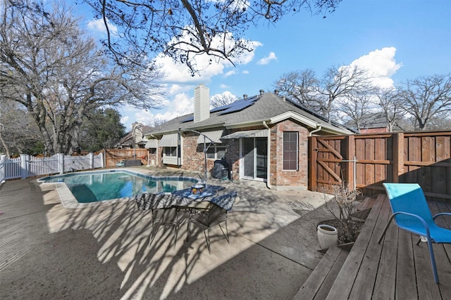 view of pool with a wooden deck