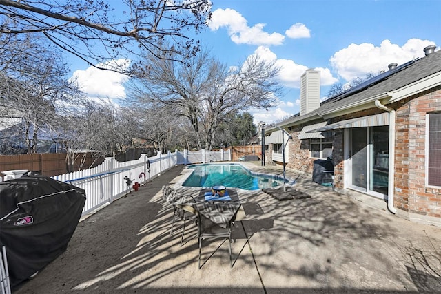 view of swimming pool with grilling area