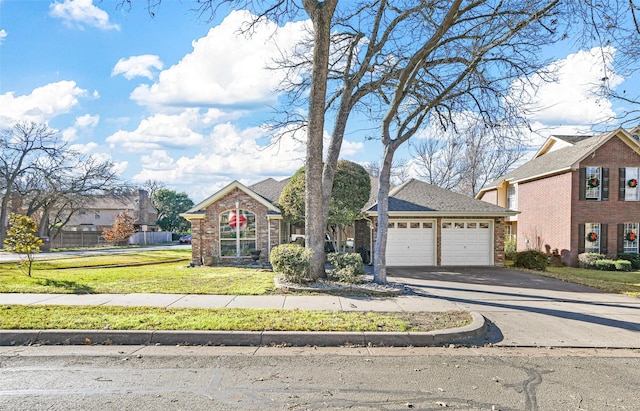 view of front of home featuring a front yard and a garage