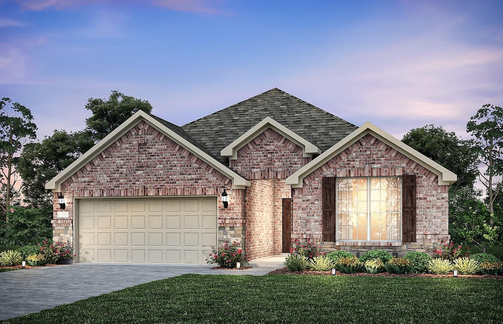 view of front of property with a garage and a yard