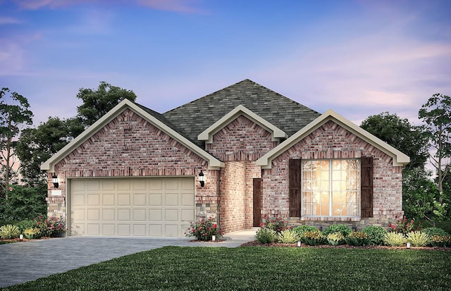 view of front of property with a garage and a yard