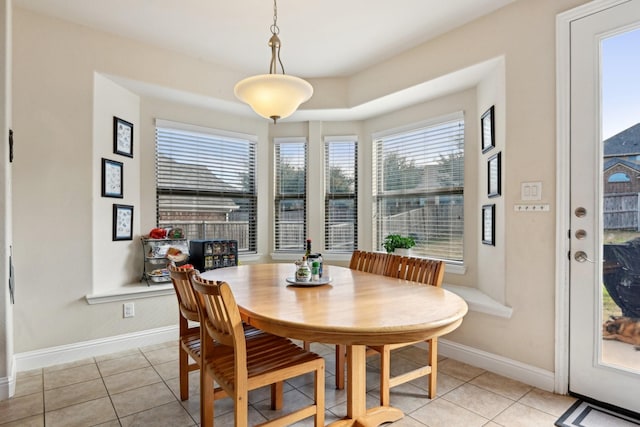 dining area featuring light tile patterned flooring and a healthy amount of sunlight