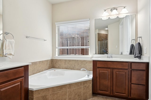 bathroom with vanity and separate shower and tub