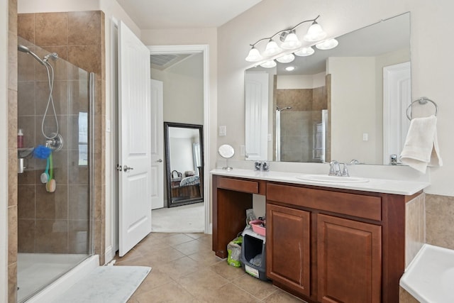 bathroom featuring tile patterned floors, vanity, and walk in shower