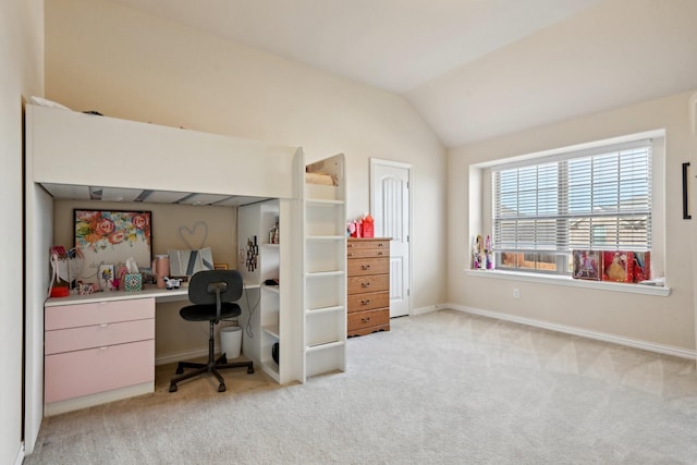 office area with light colored carpet and vaulted ceiling