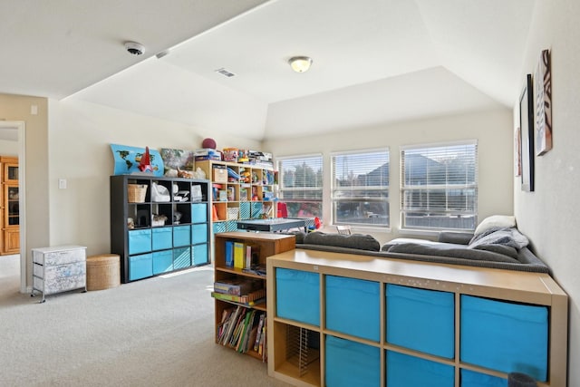 interior space with carpet flooring, a raised ceiling, and vaulted ceiling