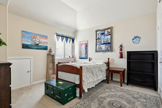 bedroom with carpet flooring and vaulted ceiling