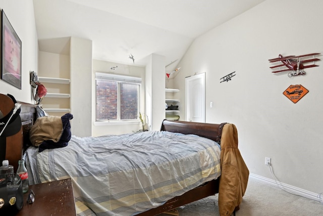 carpeted bedroom with lofted ceiling